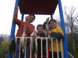 kids holding stringers of trout