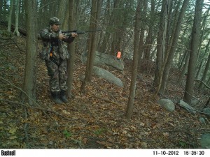 Hunter on ridge with rifle